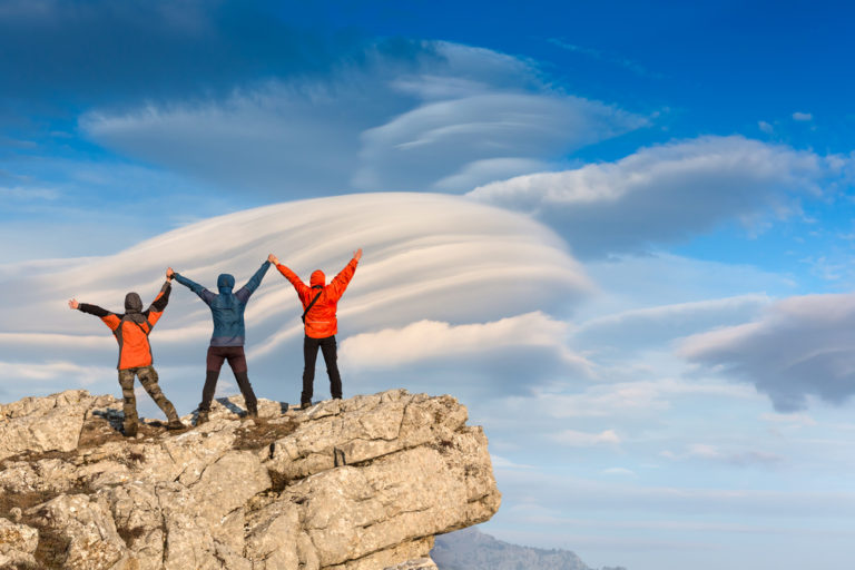 Three people on a mountain