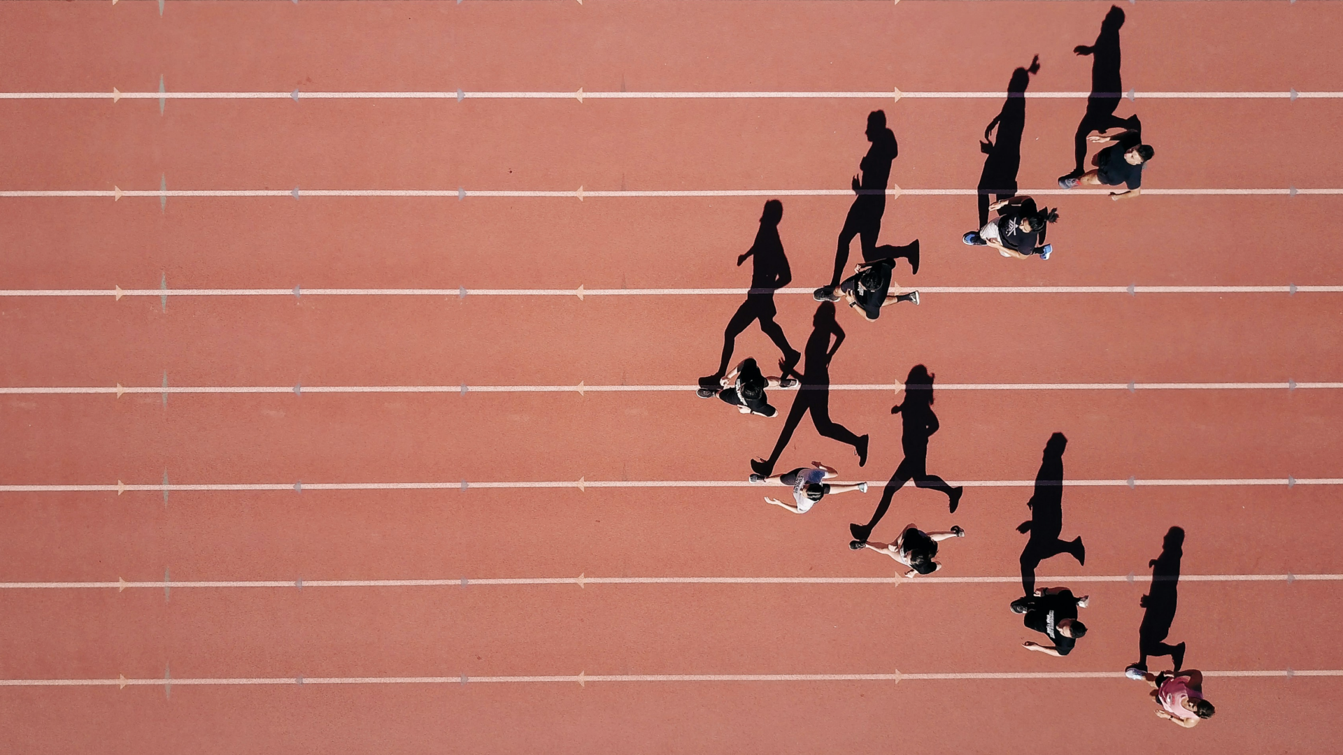 Athletes running in an arrow shape