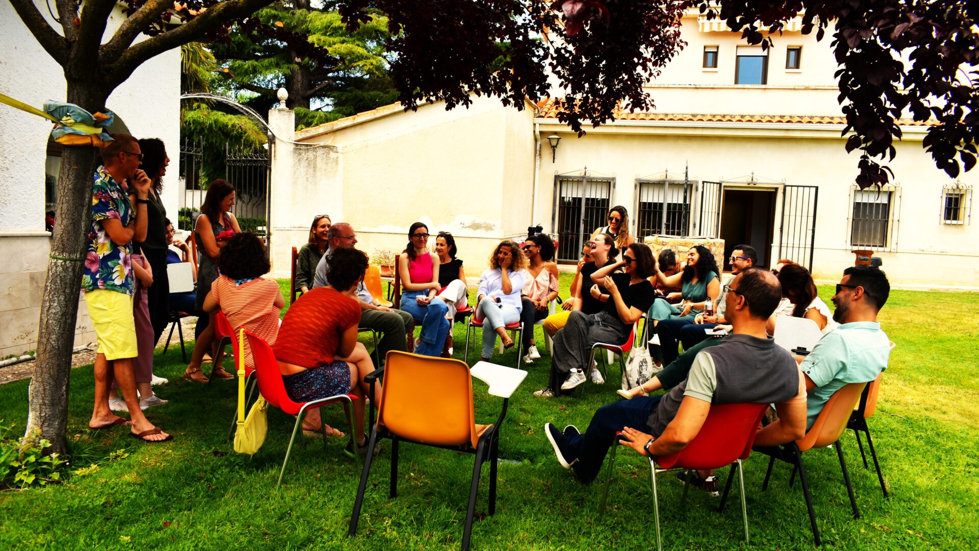 Group of stone soup community members gather in a garden and chat